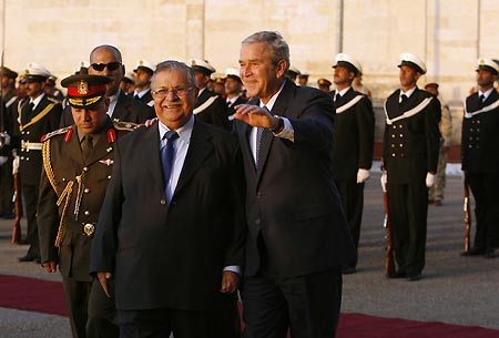 U.S. President George W. Bush walks with Iraqi President Jalal Talabani during an arrival cereomony at Salam Palace in Baghdad December 14, 2008.