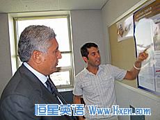 Purdue graduate student Mirwais Rahimi, from Herat Province, presents his research findings to Afghanistan's Minister of Agriculture Asif Rahimi (no relation). 