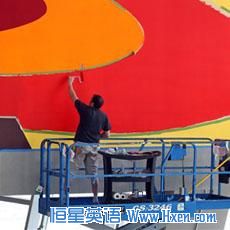 In this photograph taken on Friday, Aug. 14, 2009, Stephan Ackermann paints red on a mural by his brother the artist Franz Ackermann titled 