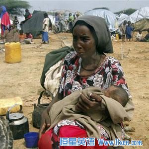 A woman with her baby sit in an open area near a camp in Mogadishu, Somalia this summer.  Famine and drought have made bad conditions worse in the area.
