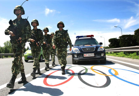 Armed policemen patrol on the Olympics special driveway in Beijing, capital of China, July 12, 2008. Armed policemen began on July 12 to patrol with 39 bulletproof vehicles on Olympics special driveways to deal with accidents and possible terror attacks. They are charged with the tasks 24 hours a day during the 2008 Beijing Olympic Games, to be held in August.